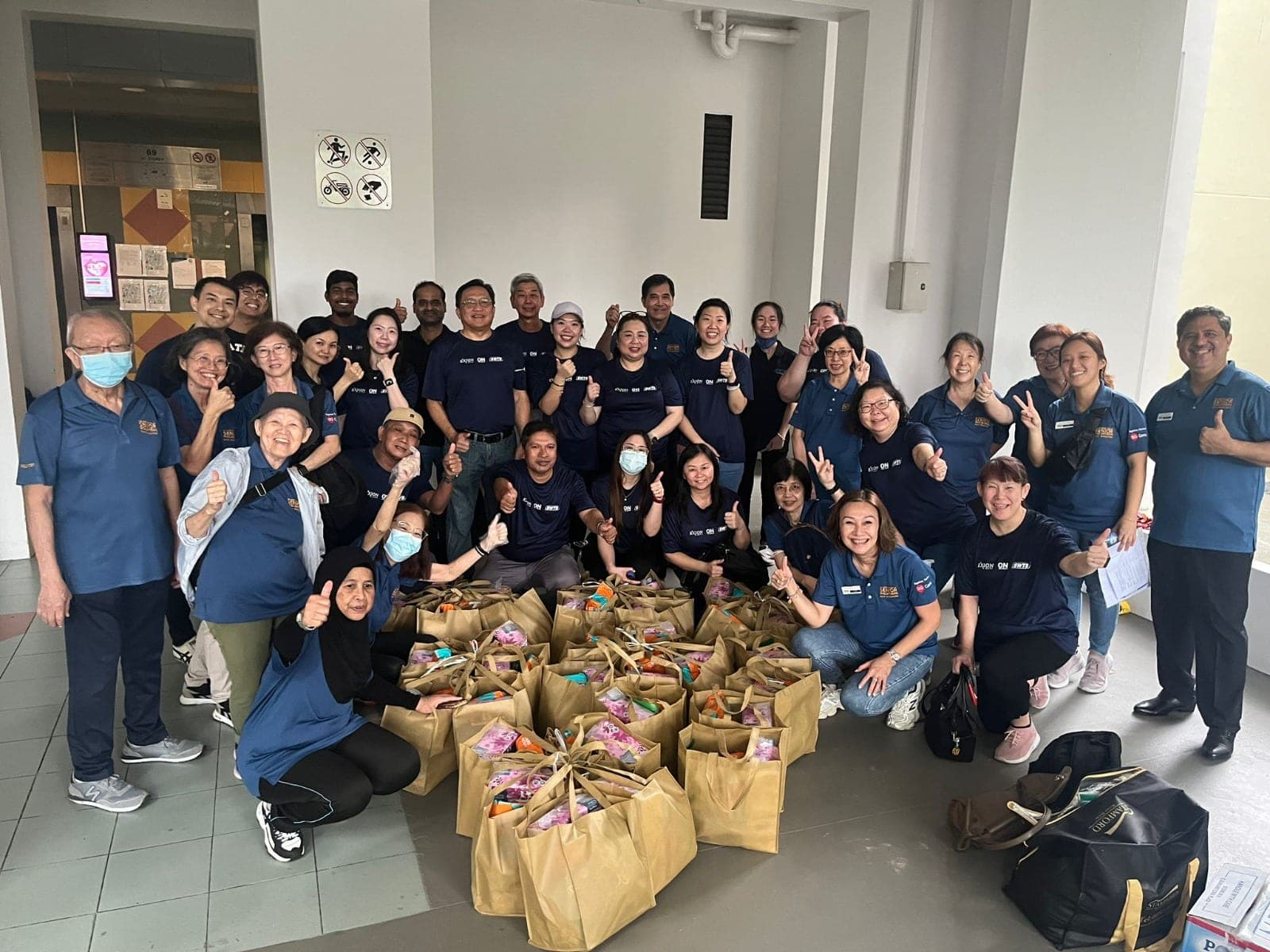 Exion and SWTS volunteers with care packages at a community distribution drive