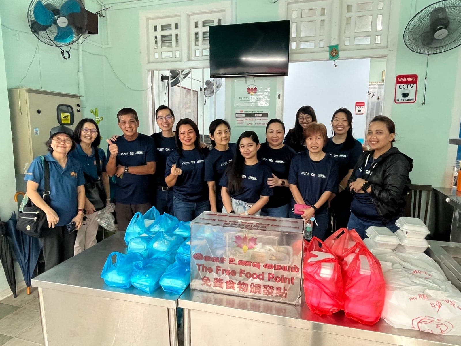 Exion volunteers serving at a free meals point