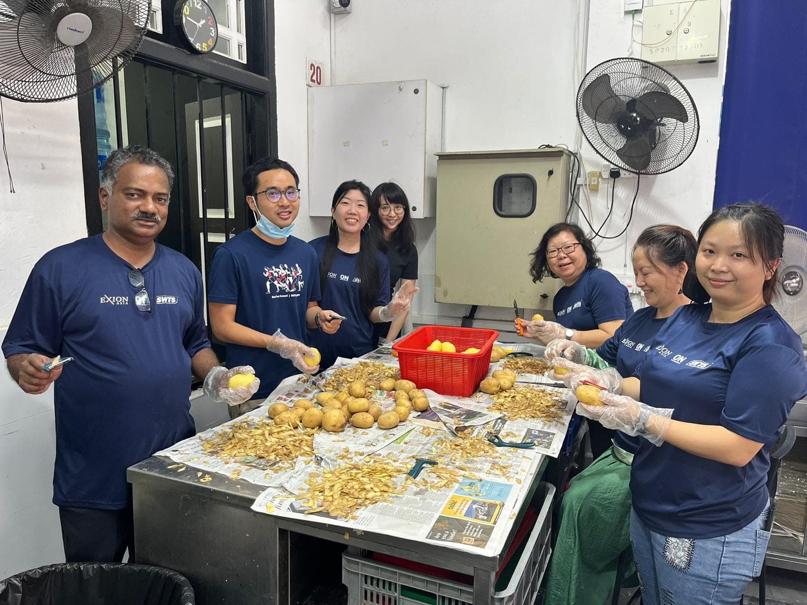 Exion volunteers preparing food in a community kitchen