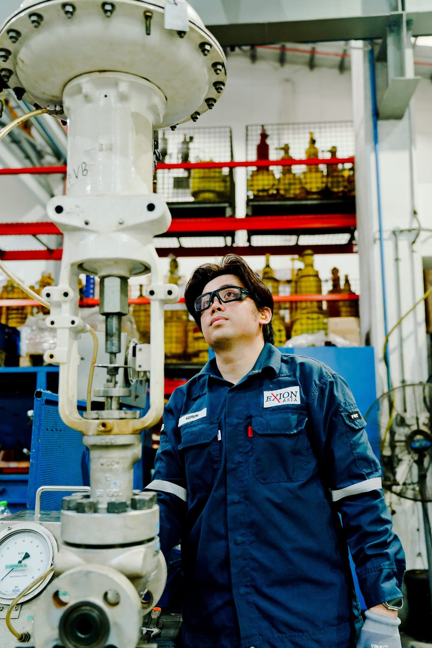 Exion engineer inspecting a control valve in the service centre